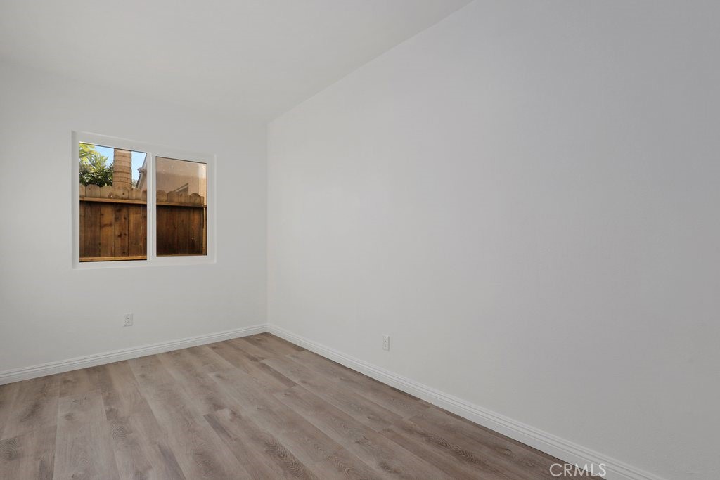 2122 East 10th Street Long Beach, CA 90804 - Photo 31 of 75 a view of an empty room with wooden floor and a window