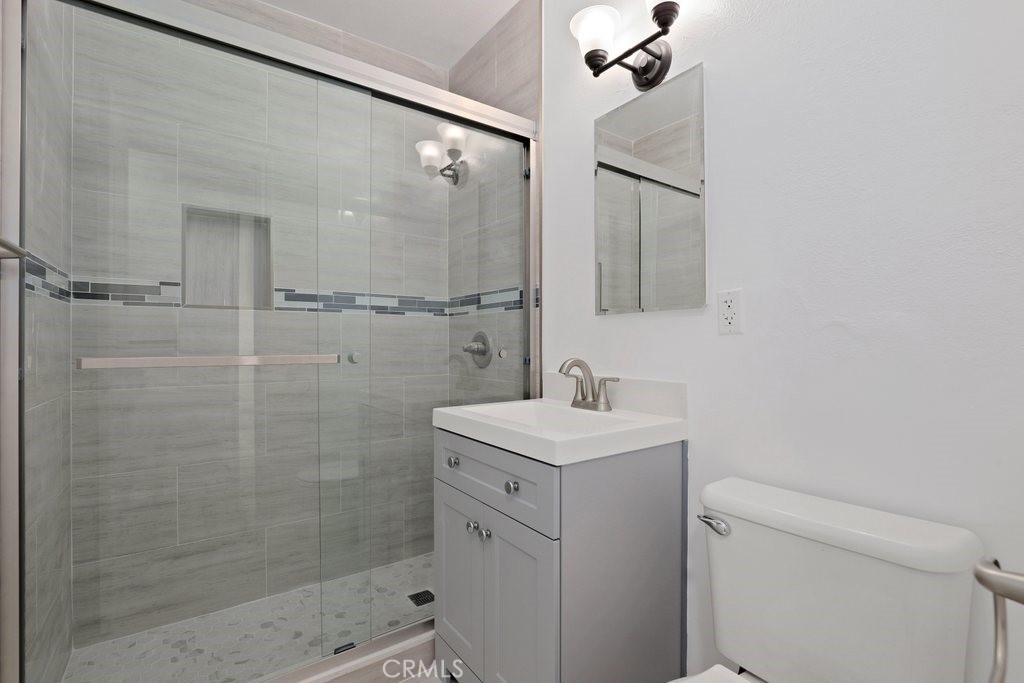 2122 East 10th Street Long Beach, CA 90804 - Photo 33 of 75 a bathroom with a shower sink vanity and toilet