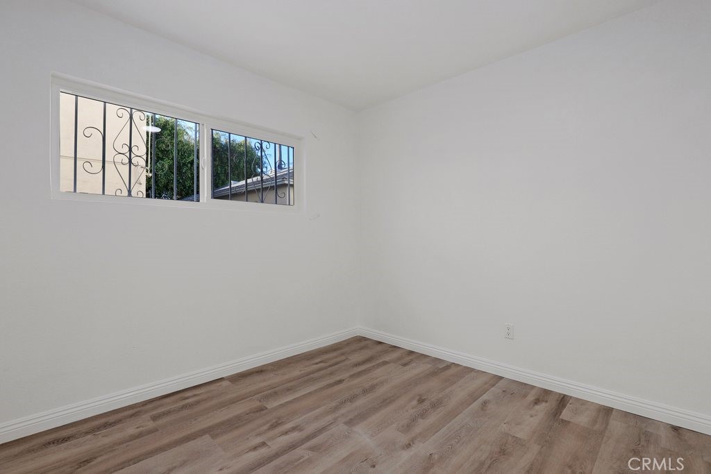 2122 East 10th Street Long Beach, CA 90804 - Photo 34 of 75 a view of an empty room with wooden floor and a window