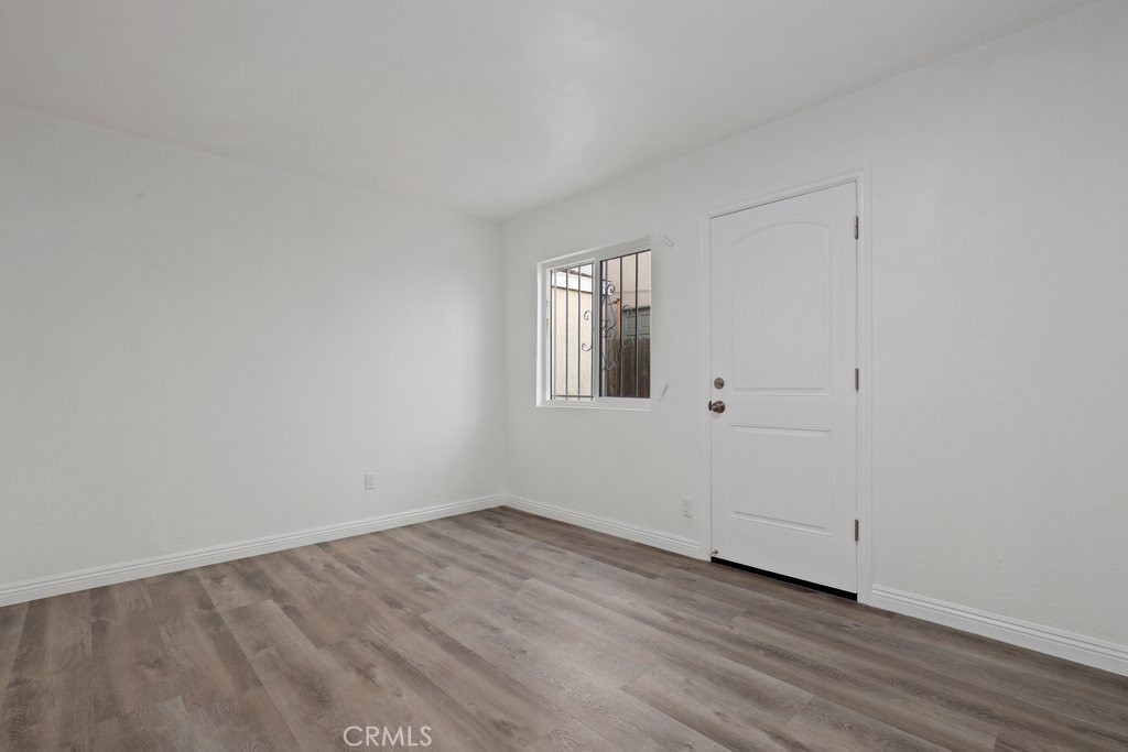 2122 East 10th Street Long Beach, CA 90804 - Photo 36 of 75 a view of an empty room with wooden floor and a window