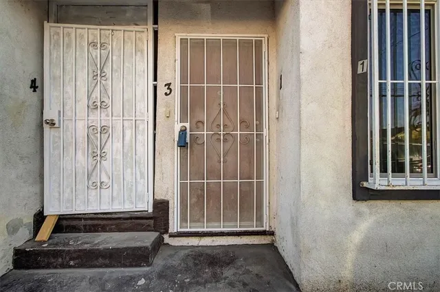 a kitchen with granite countertop white cabinets and sink
