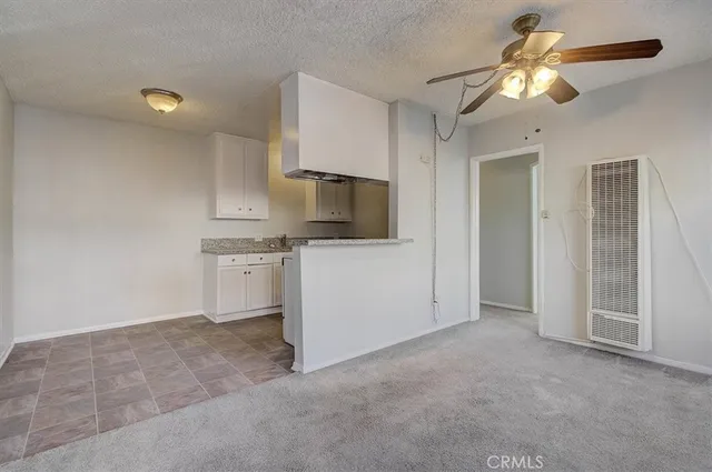 an empty room with a empty space and a ceiling fan