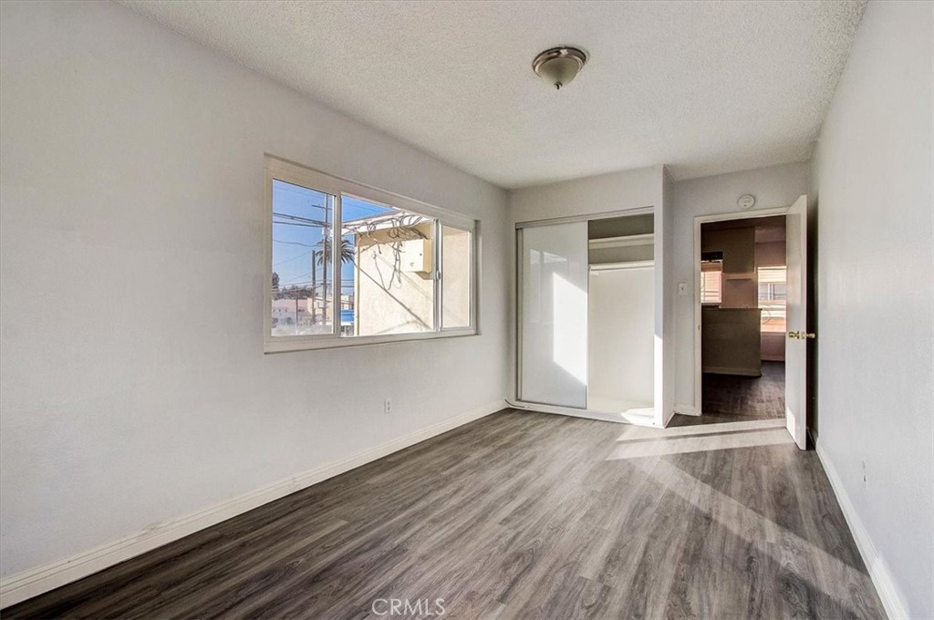2122 East 10th Street Long Beach, CA 90804 - Photo 55 of 75 an empty room with wooden floor and windows