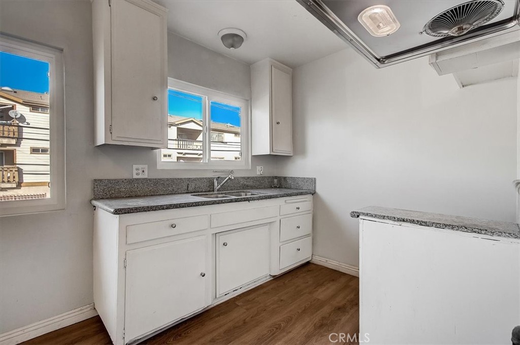 2122 East 10th Street Long Beach, CA 90804 - Photo 66 of 75 a kitchen with granite countertop white cabinets and a sink