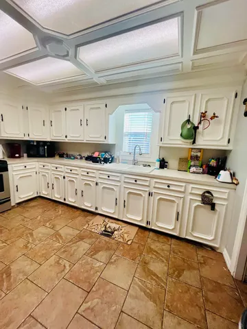 a kitchen with stainless steel appliances a sink and cabinets