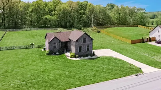 a aerial view of a house with backyard