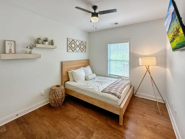 a bedroom with a bed and a window