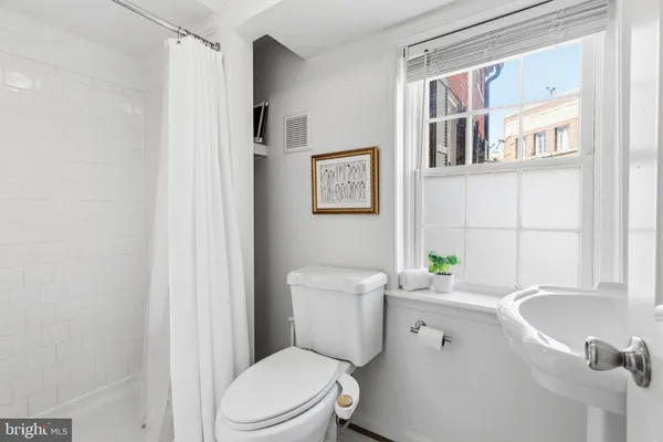 a white toilet sitting next to a bathroom sink