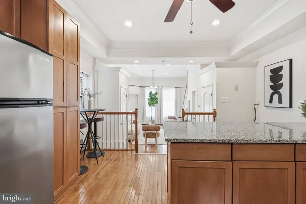 a view of living room with granite countertop furniture and a ceiling fan