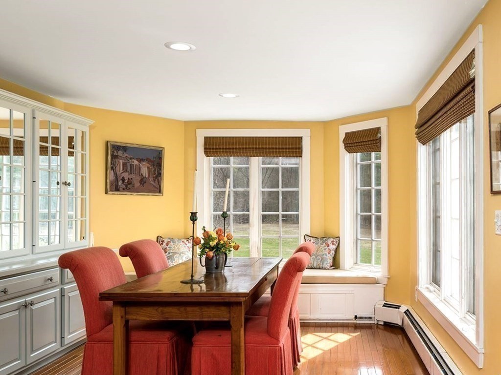 156 Larch Row Wenham, MA 01984 - Photo 14 of 38 a view of a dining room with furniture large windows and wooden floor