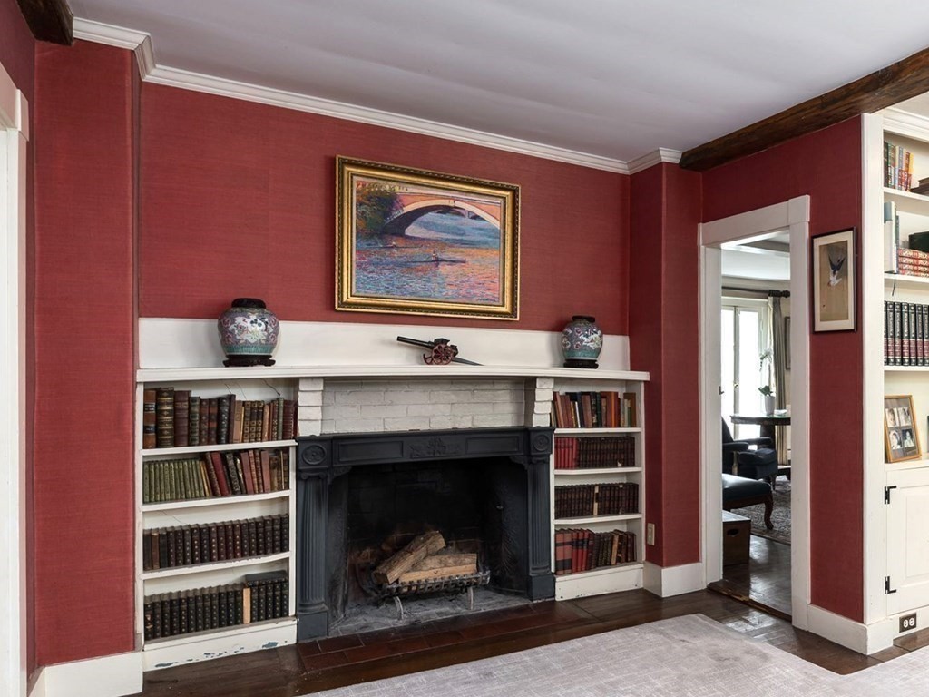 156 Larch Row Wenham, MA 01984 - Photo 16 of 38 a living room with a fireplace cabinet and a fireplace