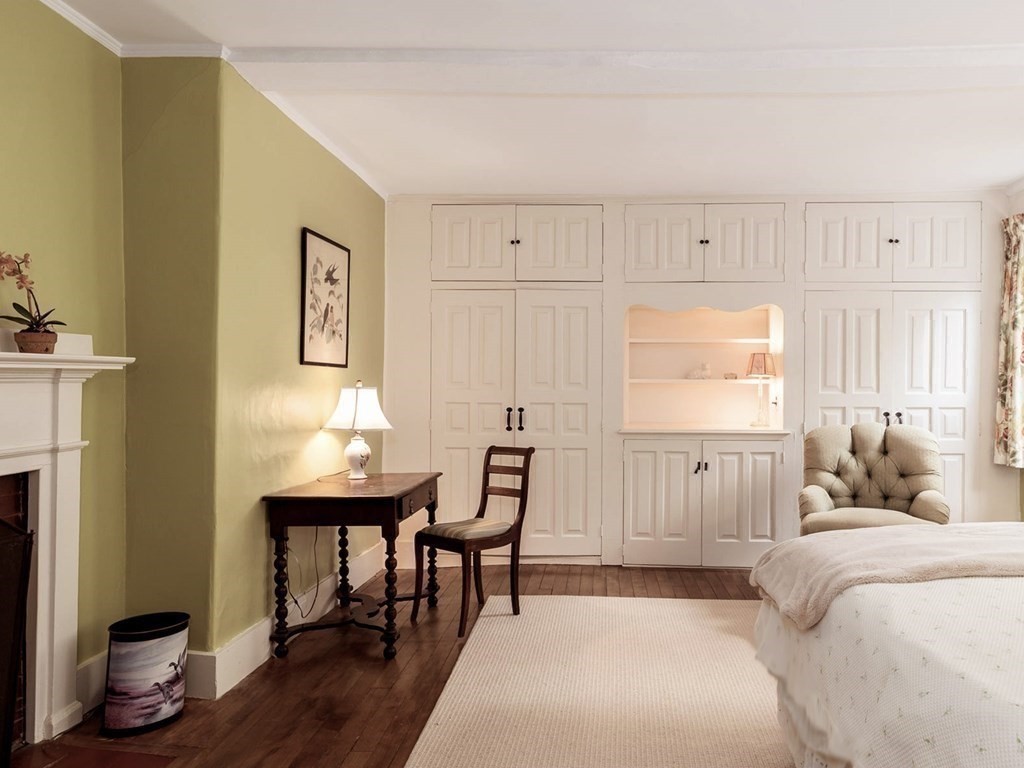 156 Larch Row Wenham, MA 01984 - Photo 22 of 38 a bedroom with a bed a table and painting