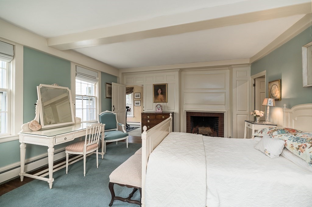 156 Larch Row Wenham, MA 01984 - Photo 23 of 38 a large bedroom with furniture fireplace and a window