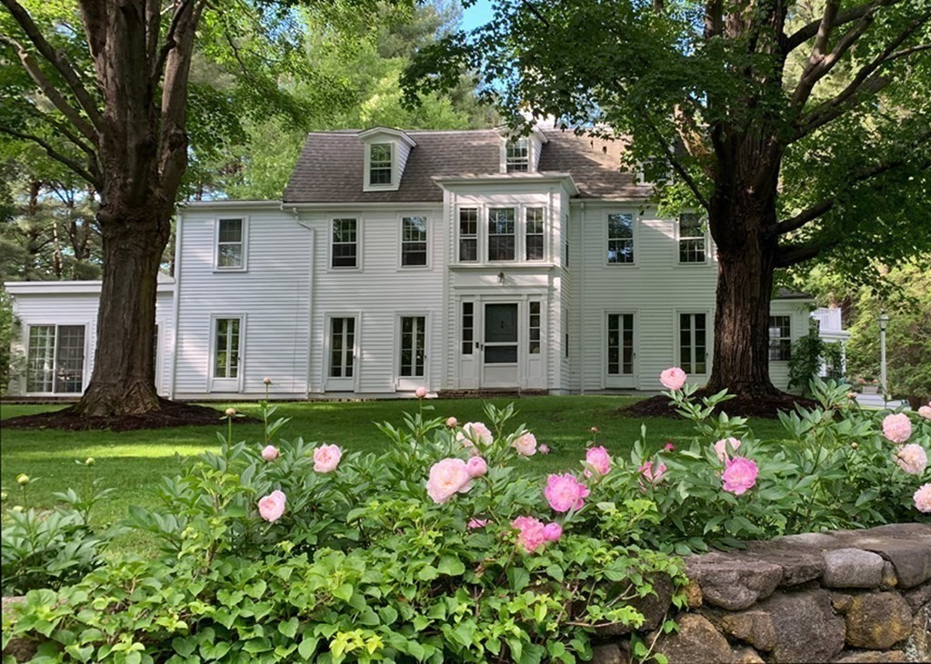 156 Larch Row Wenham, MA 01984 - Photo 5 of 38 a backyard of a house with wooden fence and flowers