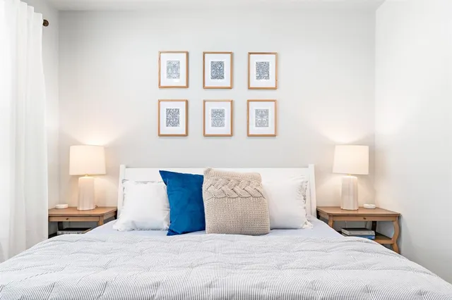 a bedroom with a bed and a lamp