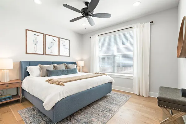a bedroom with a large bed and a window