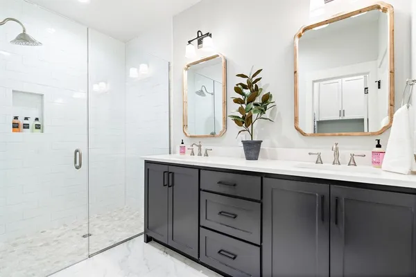 a bathroom with a double vanity sink and mirror