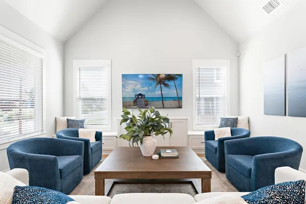 a living room with furniture potted plant and window