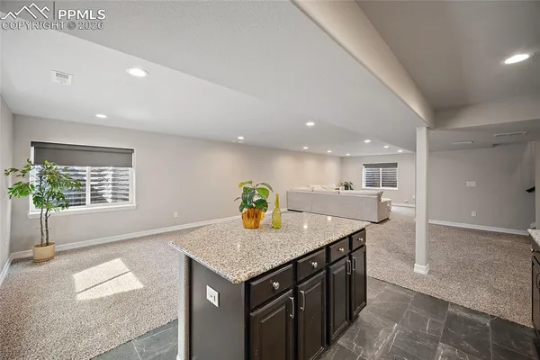 a kitchen with granite countertop counter space a sink and cabinets