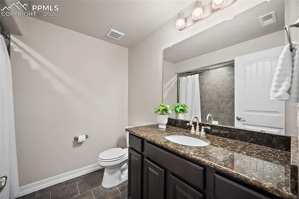 a bathroom with a granite countertop sink mirror bathtub and shower