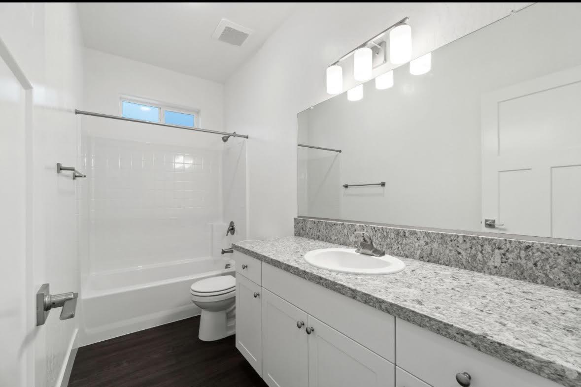 1207 Via Valencia Madera, CA 93637 - Photo 6 of 10 a bathroom with a granite countertop sink a toilet and shower