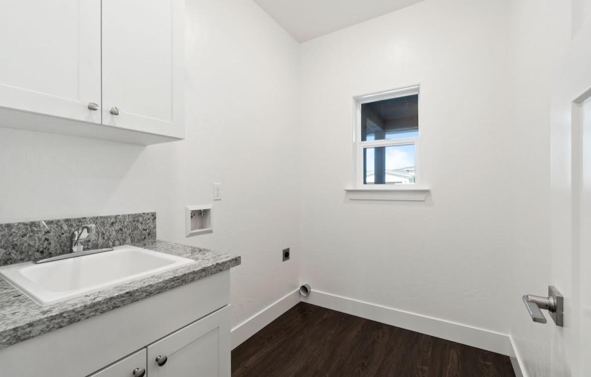1207 Via Valencia Madera, CA 93637 - Photo 7 of 10 a bathroom with a granite countertop sink and a vanity