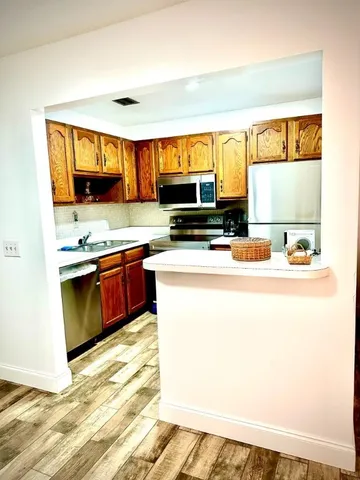 a kitchen with a refrigerator stove and sink