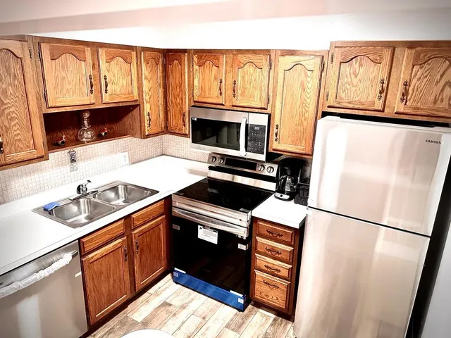 a kitchen with a sink stove and microwave