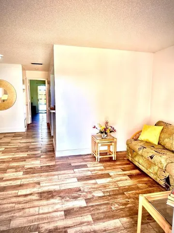 a view of a room with wooden floor and furniture