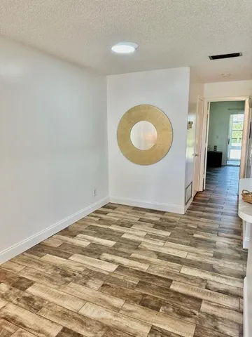 a view of a livingroom with furniture and wooden floor
