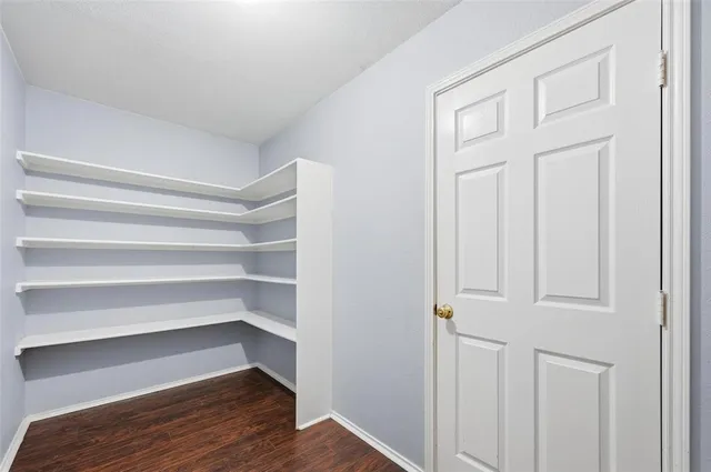 a view of walk in closet with empty racks
