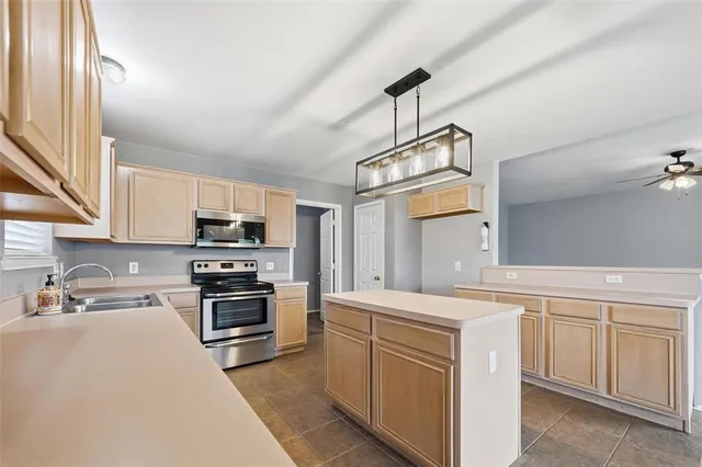 a kitchen with stainless steel appliances and white cabinets