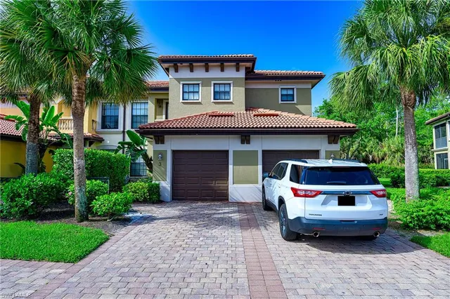a front view of a house with garage