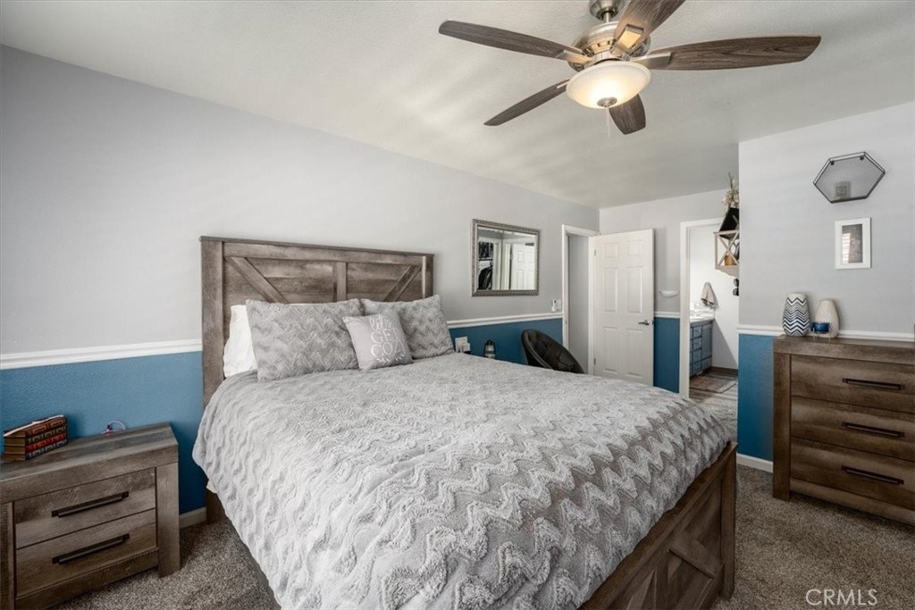 14720 McCoy Road Red Bluff, CA 96080 - Photo 15 of 49 a bedroom with a bed and a chandelier