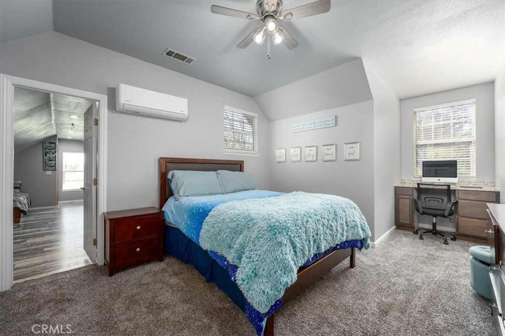 14720 McCoy Road Red Bluff, CA 96080 - Photo 21 of 49 a bedroom with a bed and a chandelier