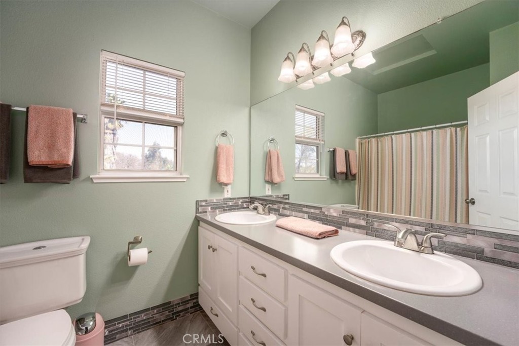 14720 McCoy Road Red Bluff, CA 96080 - Photo 24 of 49 a bathroom with a granite countertop double vanity sink mirror and toilet