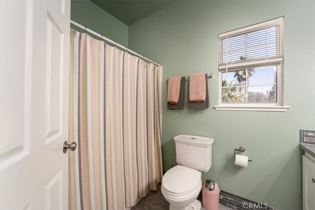 14720 McCoy Road Red Bluff, CA 96080 - Photo 25 of 49 a white toilet sitting next to a bathroom sink