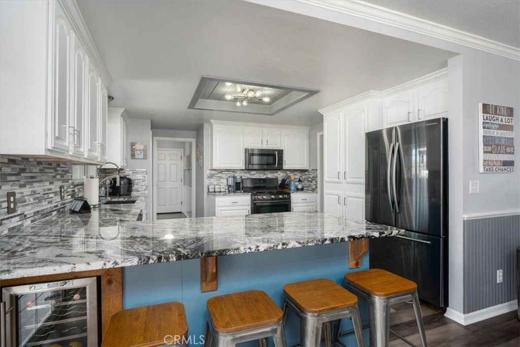 14720 McCoy Road Red Bluff, CA 96080 - Photo 9 of 49 a kitchen with furniture a refrigerator and chairs