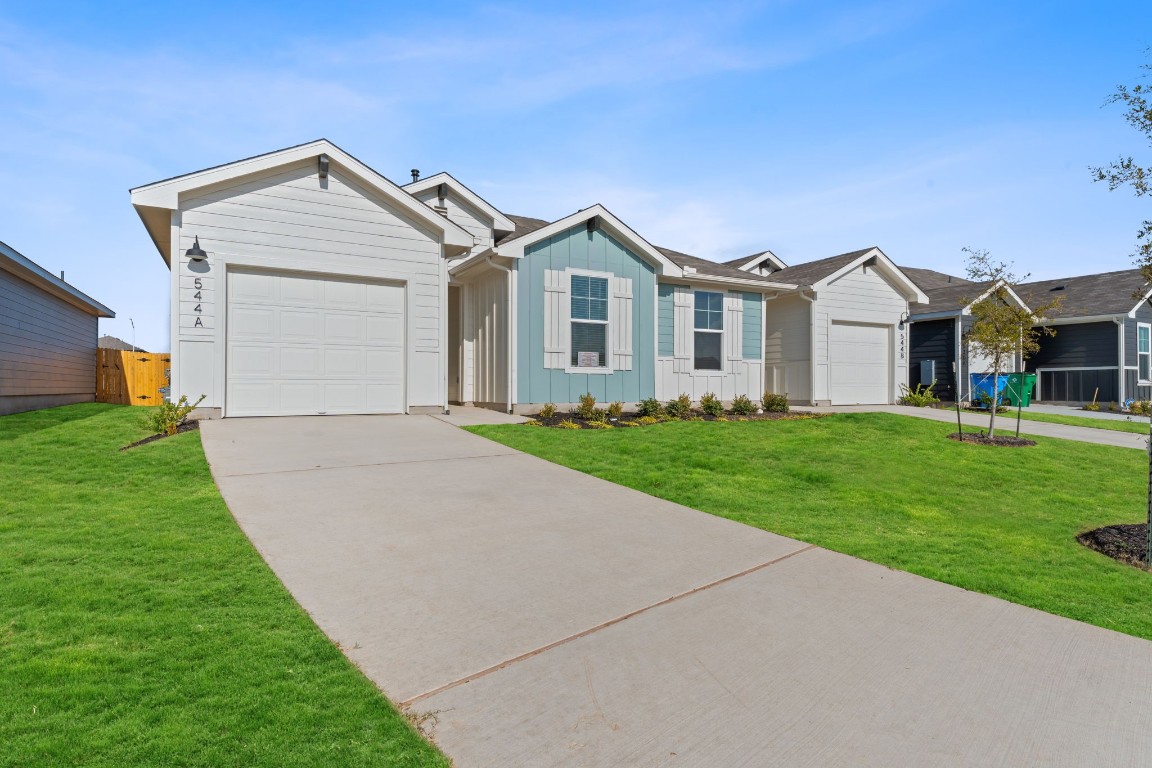 582 Arnold Loop, Unit A Kyle, TX 78640 - Photo 1 of 15 a front view of house with yard and green space