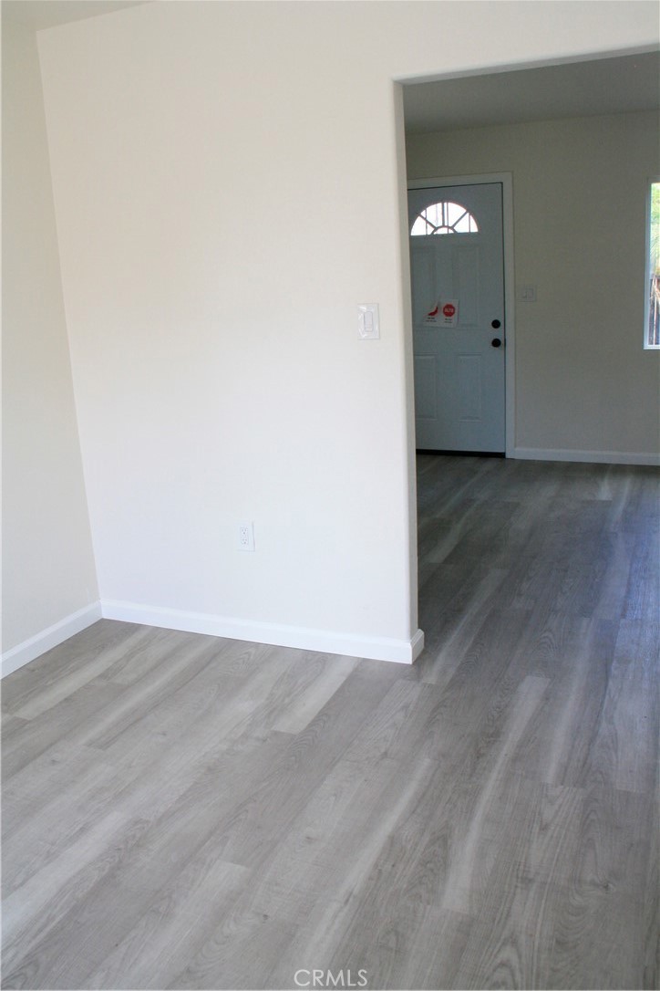 3928 Everest Avenue Riverside, CA 92503 - Photo 13 of 31 an empty room with wooden floor and windows
