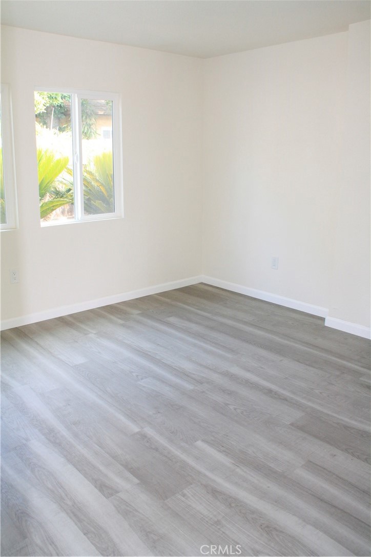 3928 Everest Avenue Riverside, CA 92503 - Photo 15 of 31 an empty room with wooden floor and windows
