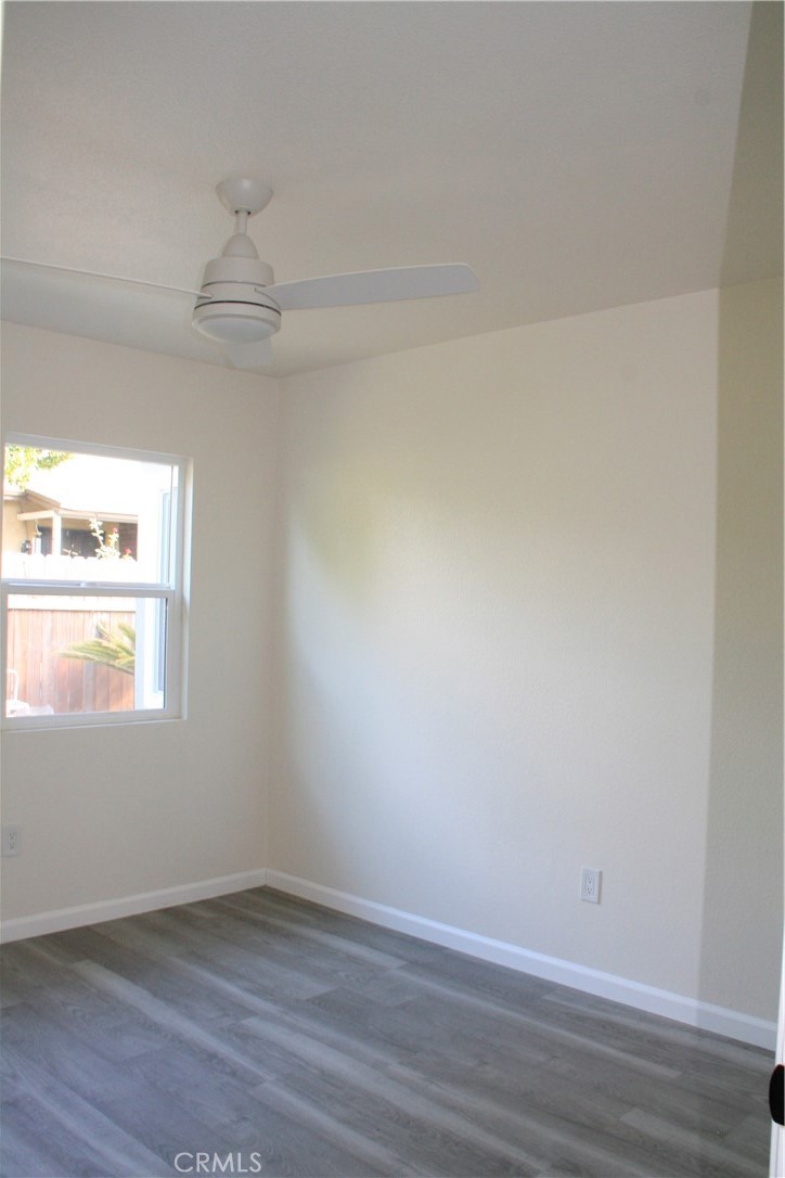 3928 Everest Avenue Riverside, CA 92503 - Photo 17 of 31 an empty room with a window and wooden floor
