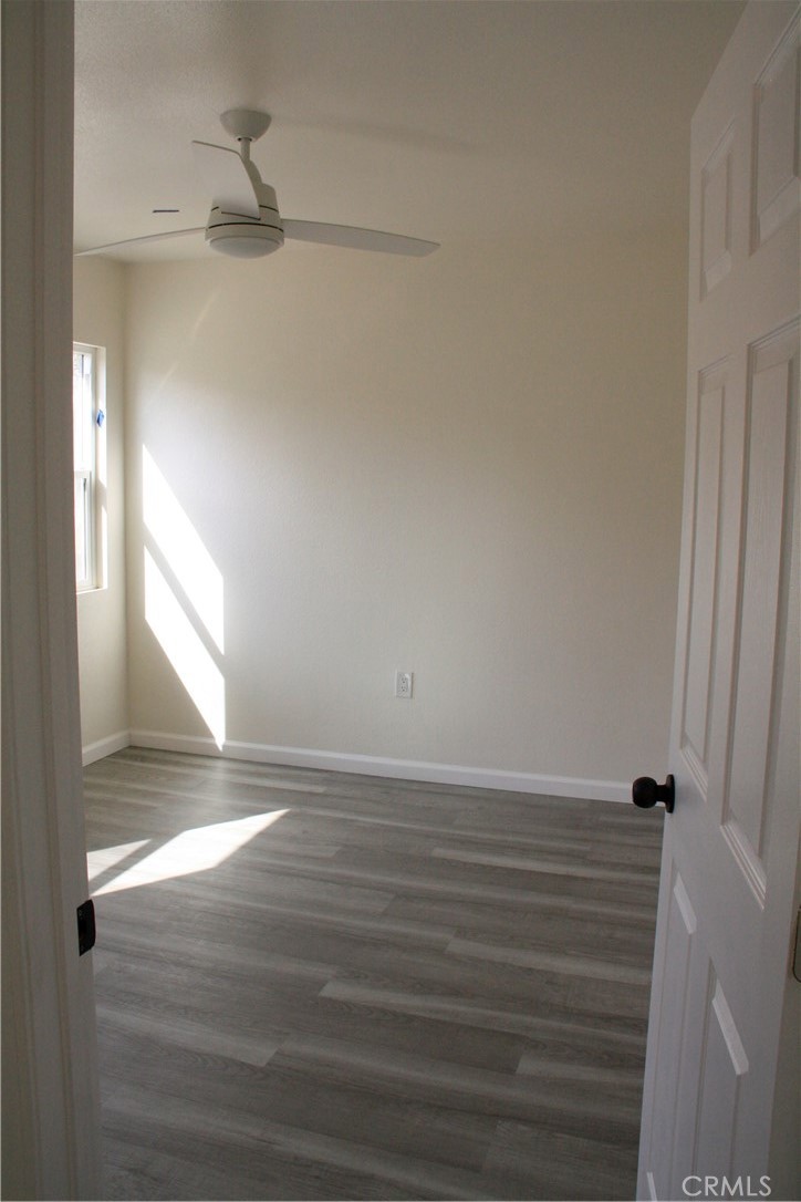 3928 Everest Avenue Riverside, CA 92503 - Photo 28 of 31 a view of an empty room with wooden floor and a window