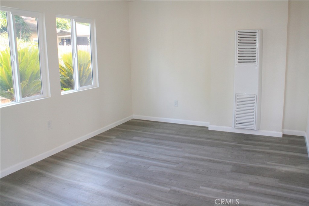 3928 Everest Avenue Riverside, CA 92503 - Photo 8 of 31 a view of an empty room with wooden floor and windows
