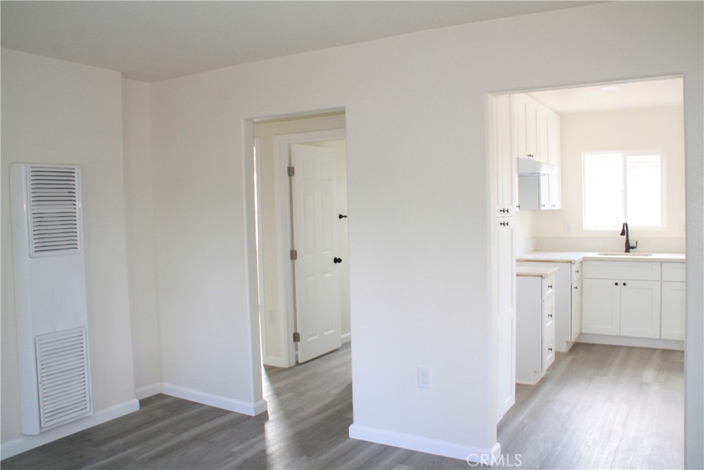 3928 Everest Avenue Riverside, CA 92503 - Photo 9 of 31 a view of a hallway with closet and wooden floor
