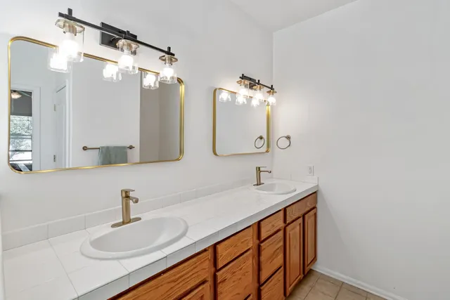 a bathroom with a sink double vanity and a mirror