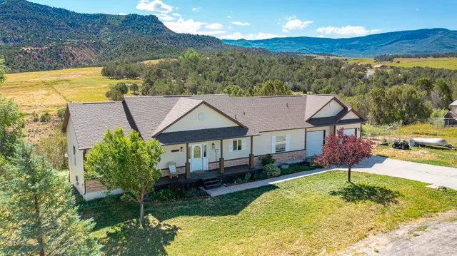 a view of a house with swimming pool and a yard