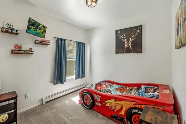 a bedroom with a bed and a window