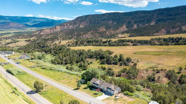 a view of a house with a yard swimming pool and mountain view
