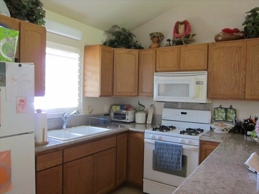 6700 Puupilo Road, Unit 1 Kapaa, HI 96746 - Photo 3 of 6 a kitchen with a sink stove top oven and cabinets